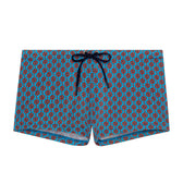 Blue swim shorts with red pattern on a white background